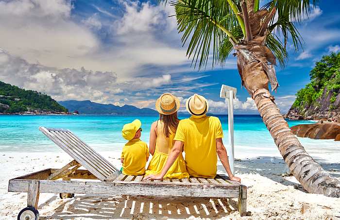 Family relaxing on a tropical beach during a Passover program vacation