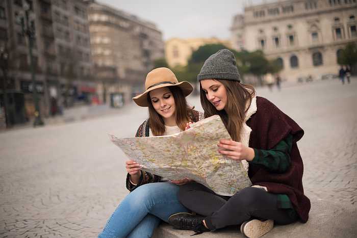 Travelers reviewing a map while planning a kosher vacation in a European city