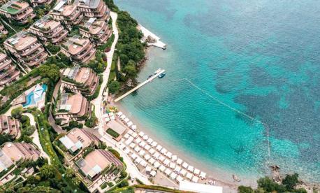 Aerial view of Dukley Hotel & Resort nestled in lush greenery along the coast
